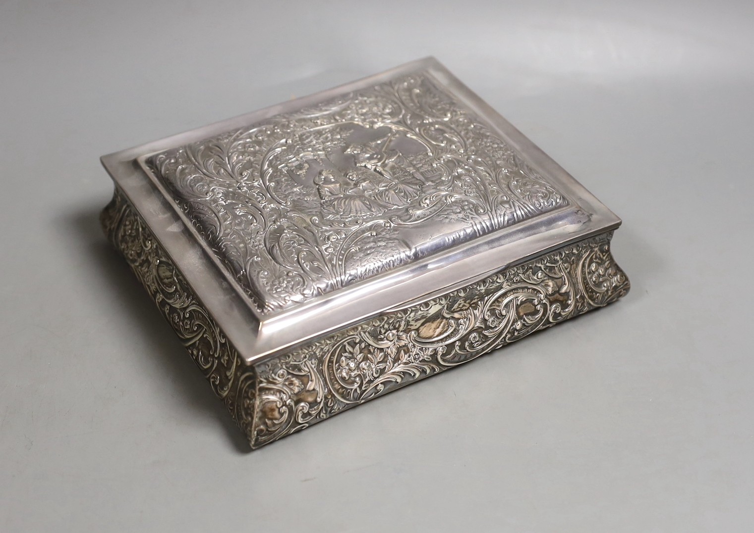 An Edwardian embossed silver mounted rectangular bombe shaped jewellery casket, Henry Matthews, Birmingham, 1905, 19.2cm.